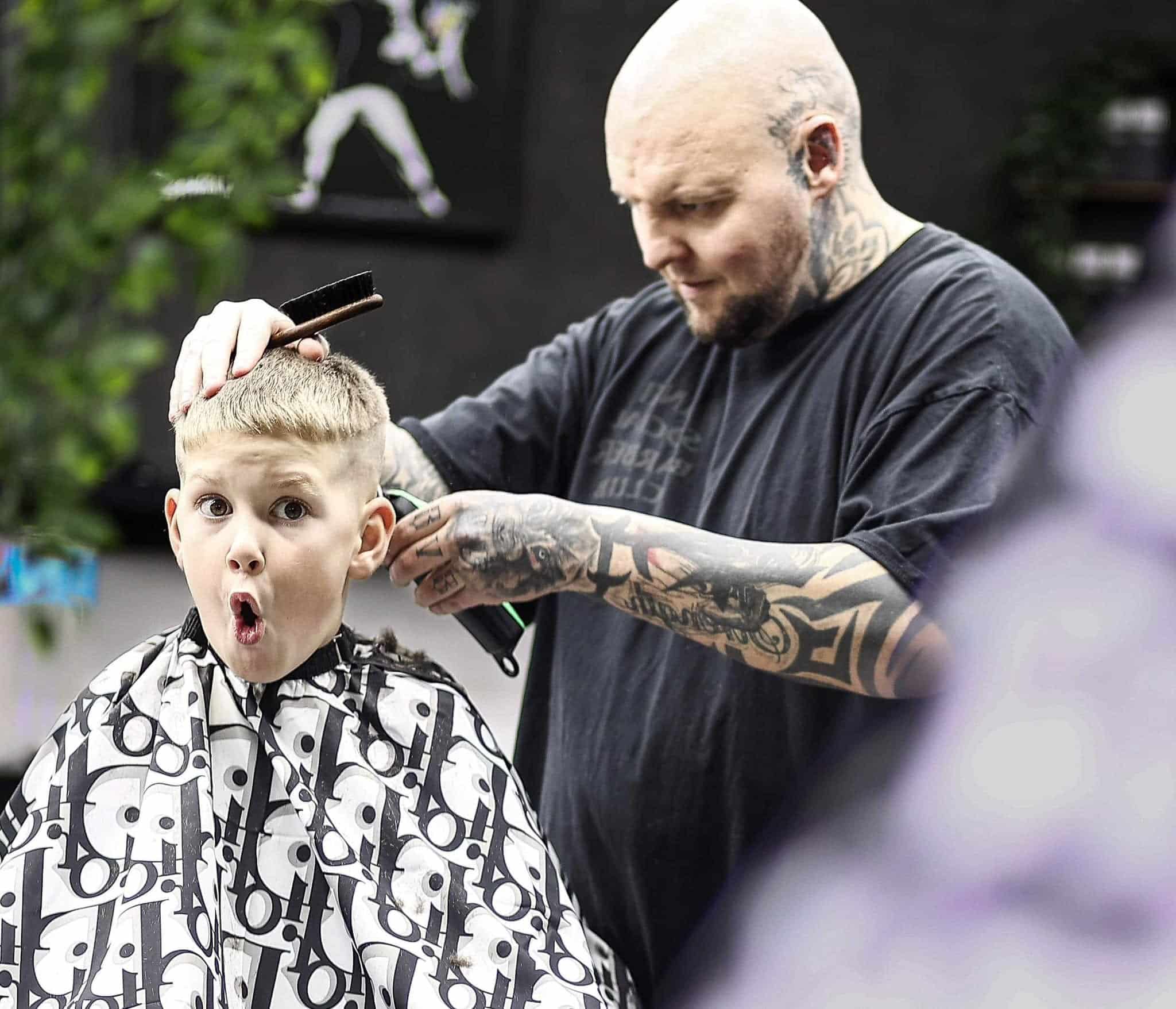 Jay giving a child a sensory-friendly haircut